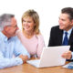 Couple talking with an adviser at a laptop